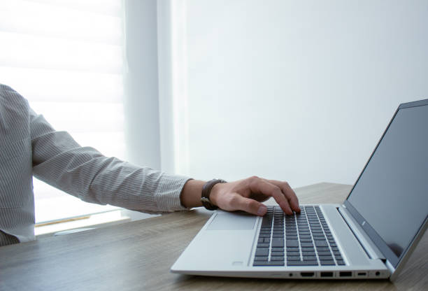 istock Business man hands typing on laptop computer keyboard, surfing the internet at the office with copy space for web banner, IT worker and business concept. 2157964648