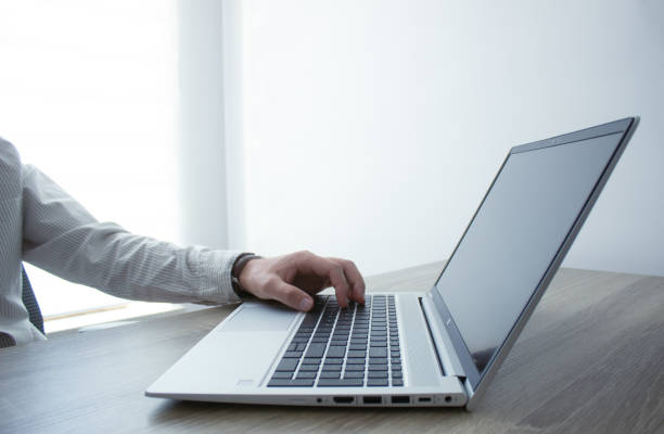 istock Business man hands typing on laptop computer keyboard, surfing the internet at the office with copy space for web banner, IT worker and business concept. 2157964652