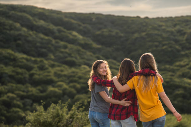 istock Female friends standing embraced on a mountain 2157965407