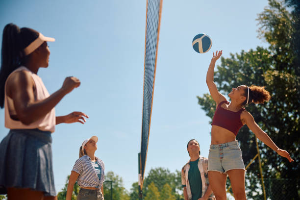istock Group of young people enjoying in summer while playing beach volleyball. 2157966164