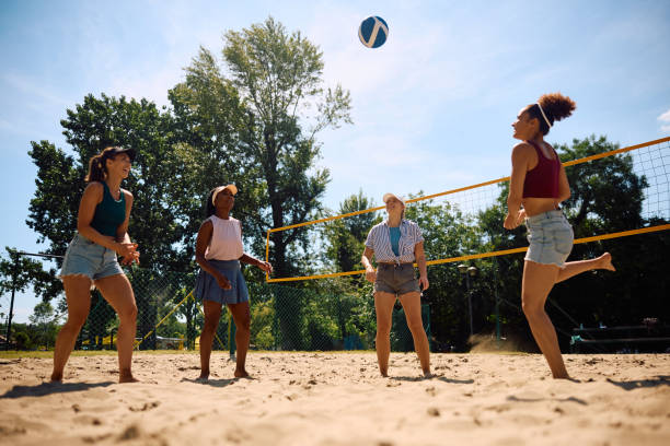 istock Young women having fun while playing volleyball on the beach. 2157966258