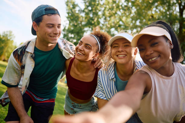 istock Young happy friends having fun while taking selfie in the park. 2157966351