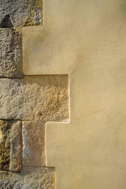 istock Beige stucco and stone brick wall texture detail 2157966609