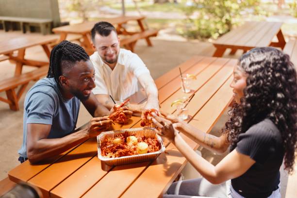 istock Three friends eating seafood and having fun at the restaurant 2157968269