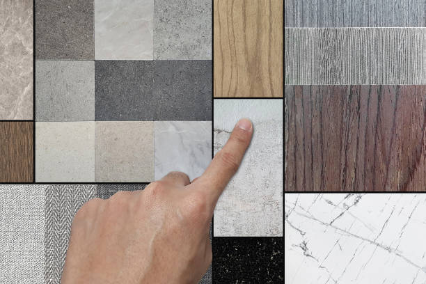 istock interior designer choosing material samples in mood board consists wooden veneers, stone ceramic tiles, fabric laminated, white carrara marble, black terrazzo, wooden vinyl flooring in close up view. 2157970514