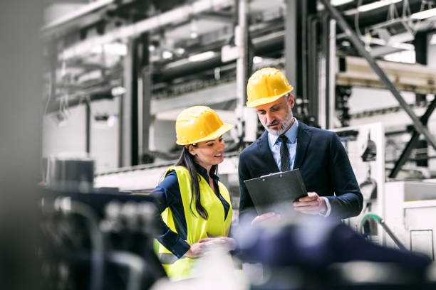 istock Warehouse worker shaking hand with logistics employee in warehouse, planning transport of products, goods, talking shipping process. 2157971422