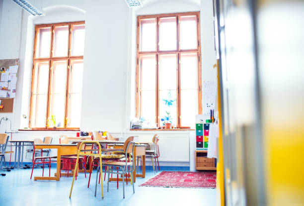 istock Elementary classroom with big windows, no students. Last day of school, summer break. Back to school concept. 2157972394
