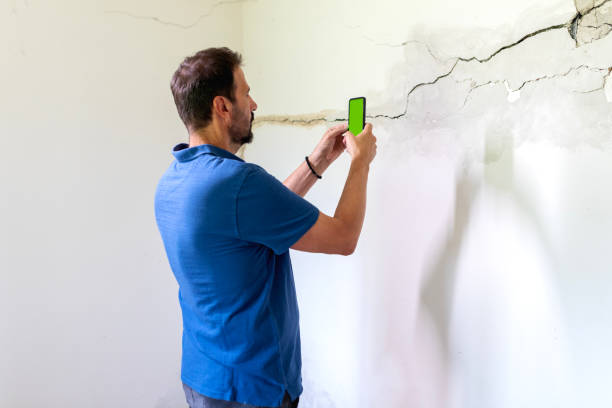 istock Mature man looking at a wall damaged after the earthquake 2157978798