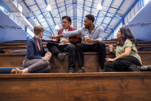 istock Marketing meeting and work discussion. Diverse team collaboration on steps in creative working space 2157979798