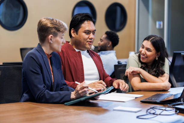 istock Project discuss in modern office. Diverse team with tablets and laptops is in discussion 2157979806