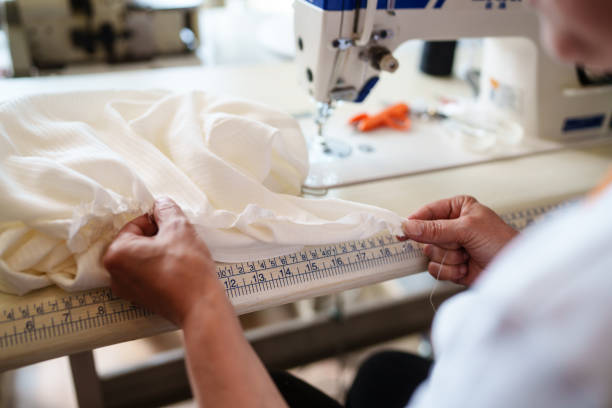 istock Tailor measuring dress on sewing table. 2157981761