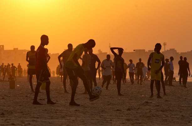 Dakar. Senegal. October 13, 2021. Residents of the capital are massively playing beach soccer on the west coast of Africa at sunset on a sultry day.