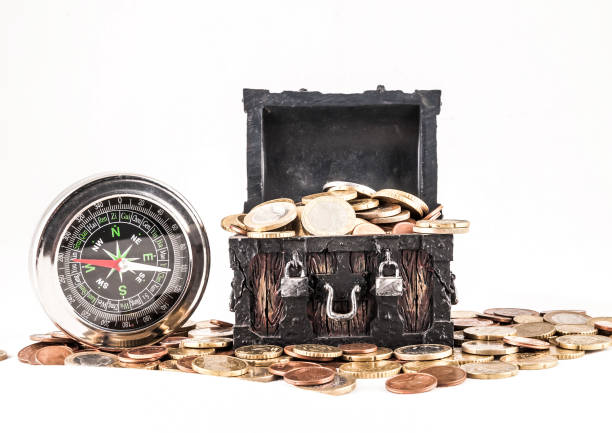 Treasure chest with jewelry and coins, compass and shells on a vintage map