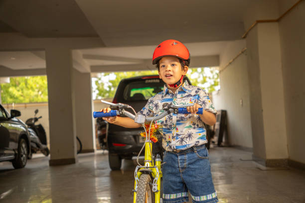 Country cycling walk. Young rider kid in helmet and sunglasses riding bicycle. Happy child have fun on empty trail. Active family lifestyle, sports, outdoor recreational activities on summer holidays.