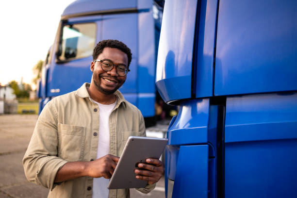 istock Smiling black drier standing in front of the truck. 2157985774