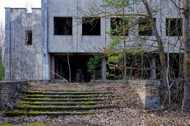 istock A dilapidated building with the word on top, surrounded by bare trees and overgrown vegetation. An abandoned restaurant in Pripyat. Ruins of a building in a city contaminated with radiation. 2157988271