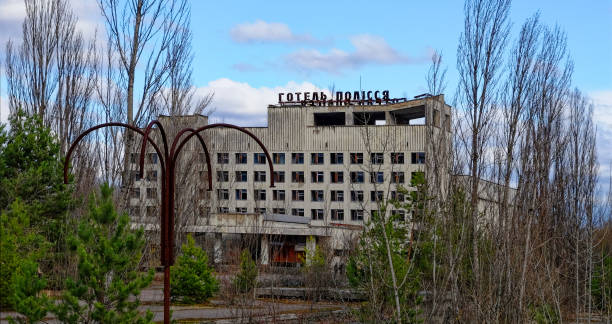 istock A dilapidated building with broken windows surrounded by overgrown trees. 2157988279