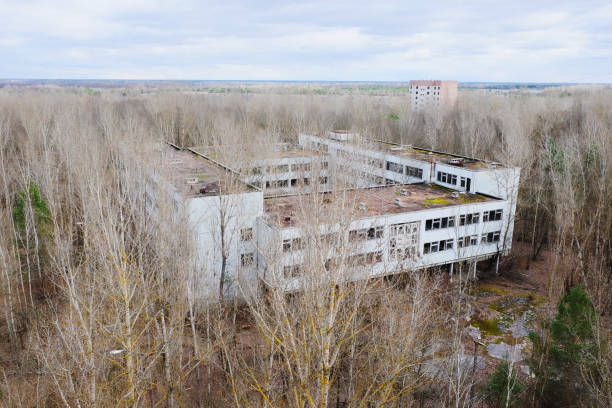 istock A ruined edifice, its windows shattered, overtaken by nature. 2157988304