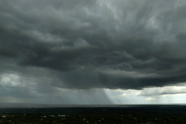 Heavy rain falling down from stormy clouds during thunderstorm on dark sky. Moving and changing cloudscape weather.
