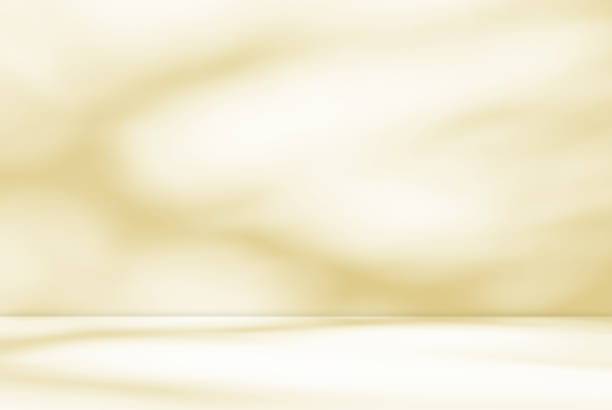 istock Empty yellow golden pastel room studio with shadow of leaves overlay. 2157992458