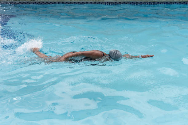 Woman Swimming Freestyle in Pool