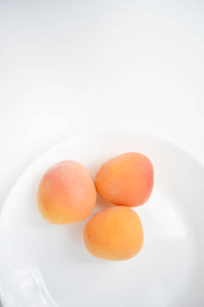 Yellow plums on a white plate. Fresh fruits.