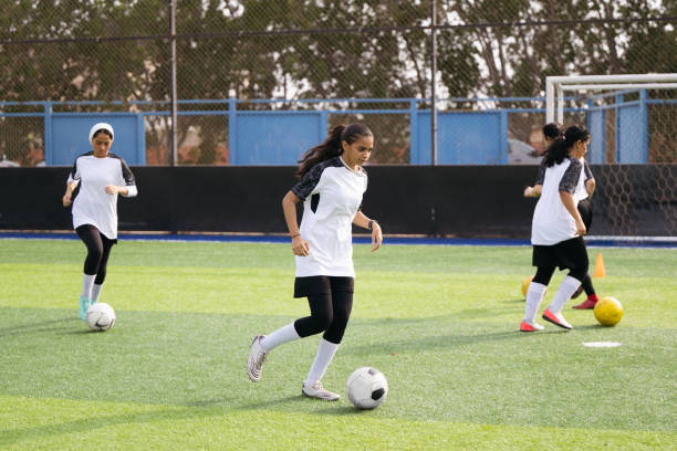 istock Saudi female athletes dribbling during football practice 2157998720
