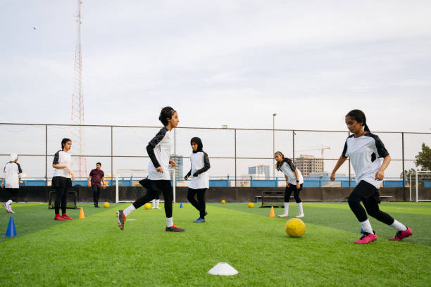 istock Saudi teens running and dribbling during football practice 2157999385