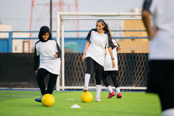 istock Saudi footballers developing dribbling skills on field 2157999390