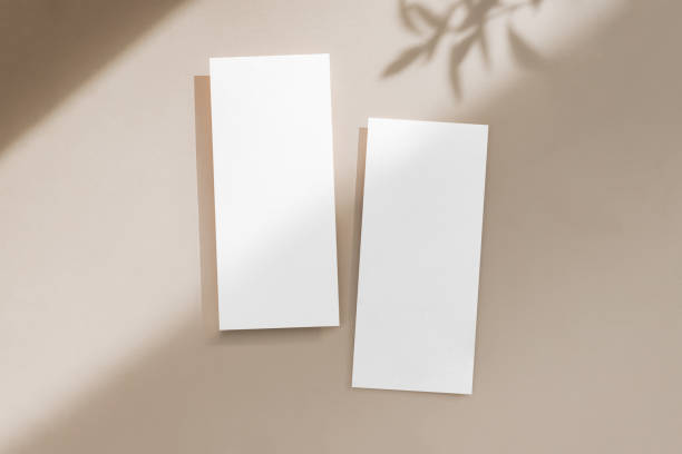istock Two white blank menu cards mockup on neutral background with light and shadow 2157999426