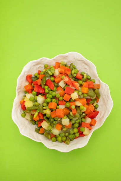 Mix of fresh vegetables in white beautiful bowl, top view
