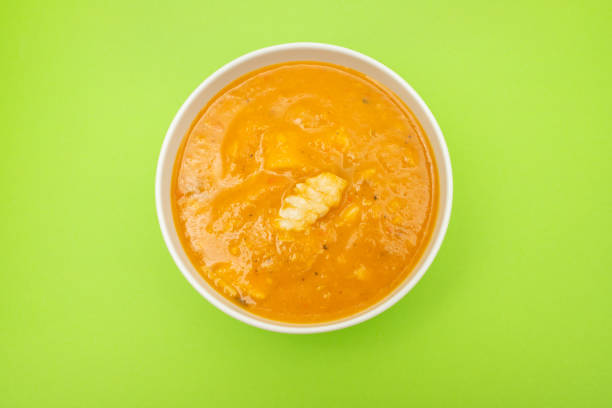 Creamy fish soup in white bowl. Top view.