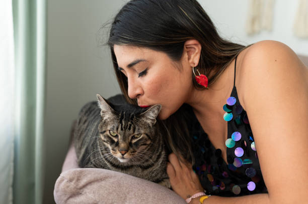 istock Woman kissing a cat on the forehead 2158001016