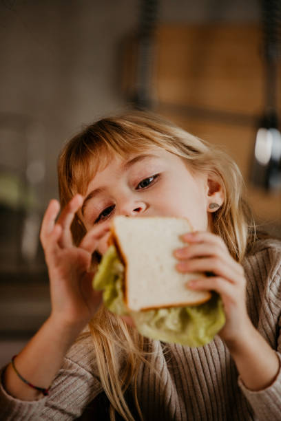 istock Preschool child eating sandwich 2158002623