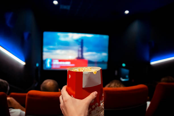 istock Male hand holding Pop corn bag in cinema 2158004459