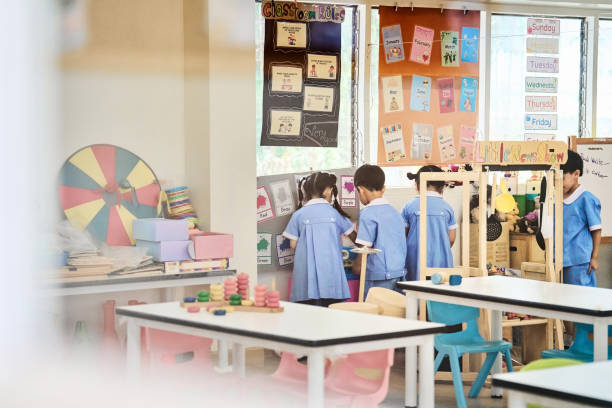 Group of children engaged in a coloring project in kindergarten class