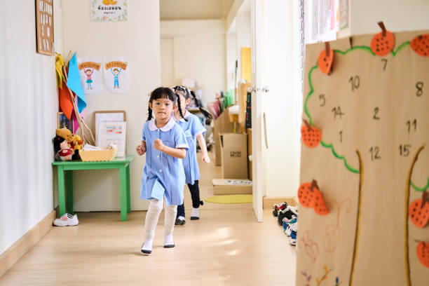 istock Group of kindergarten students running out of the classroom 2158008151