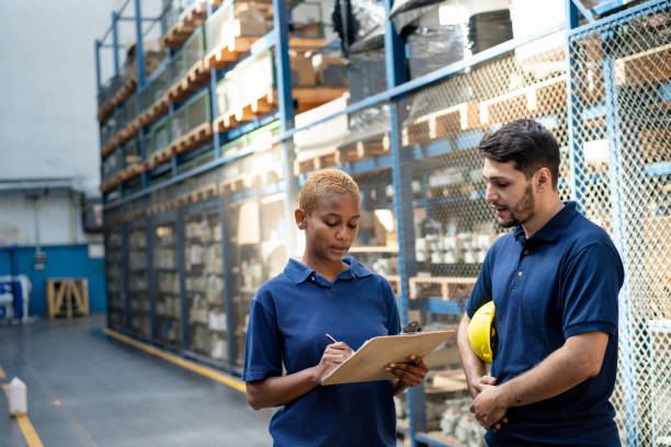 istock Two coworkers discussing delivery plan in the warehouse 2158009562