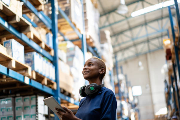 istock Woman using digital tablet standing in warehouse checking stock 2158009587