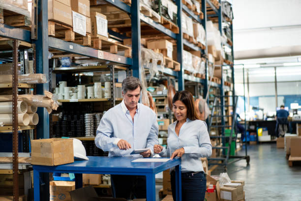 istock Man and woman using digital tablet for dispatch scheduling in warehouse 2158009639