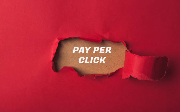 istock A red background with a hole in it and the words pay per click written in white 2158010374