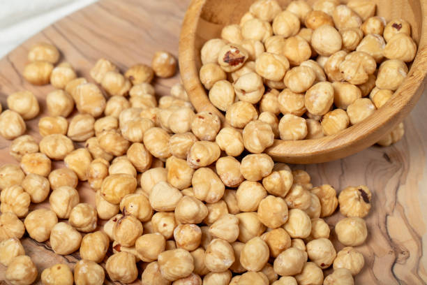 istock Hazelnuts on wood background. Roasted hazelnuts in a bowl. Close up 2158010438