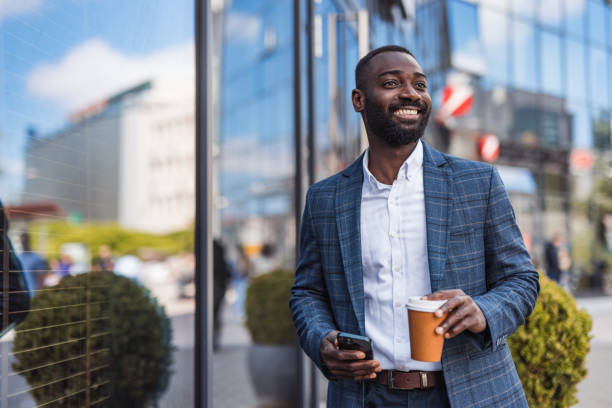 Grown up, a businessman, a black man next to an office building