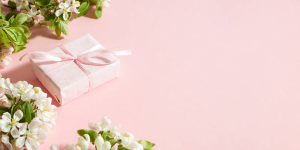 istock Spring flowers and  gift box on a pink background 2158011096