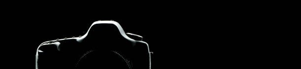 istock silhouette of a photographic camera on black background 2158011437
