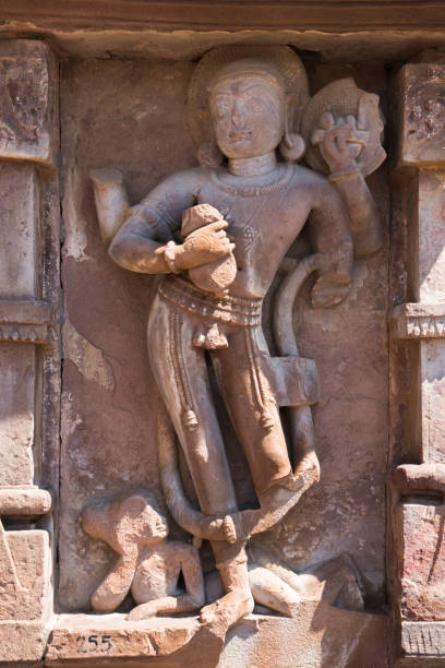 A statue portraying a man with a serpent coiled around his midsection, Ancient Indian Menal Shiv Temple