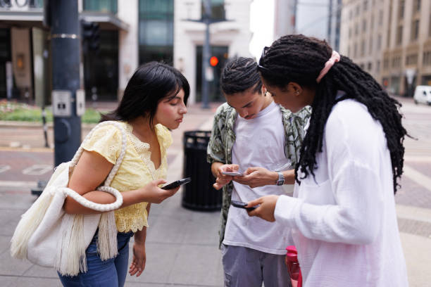 istock Young students using online maps for directions in a big city 2158012549