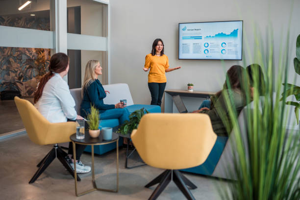 istock Hispanic Businesswoman Leads Presentation in Modern Office 2158016306