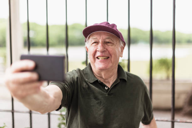 istock Older Man Taking a Selfie Outdoors 2158016787
