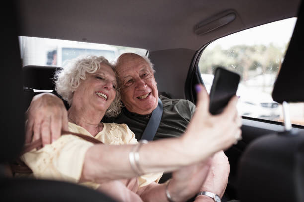 istock Happy Elderly Couple Taking a Selfie in a Car 2158016806